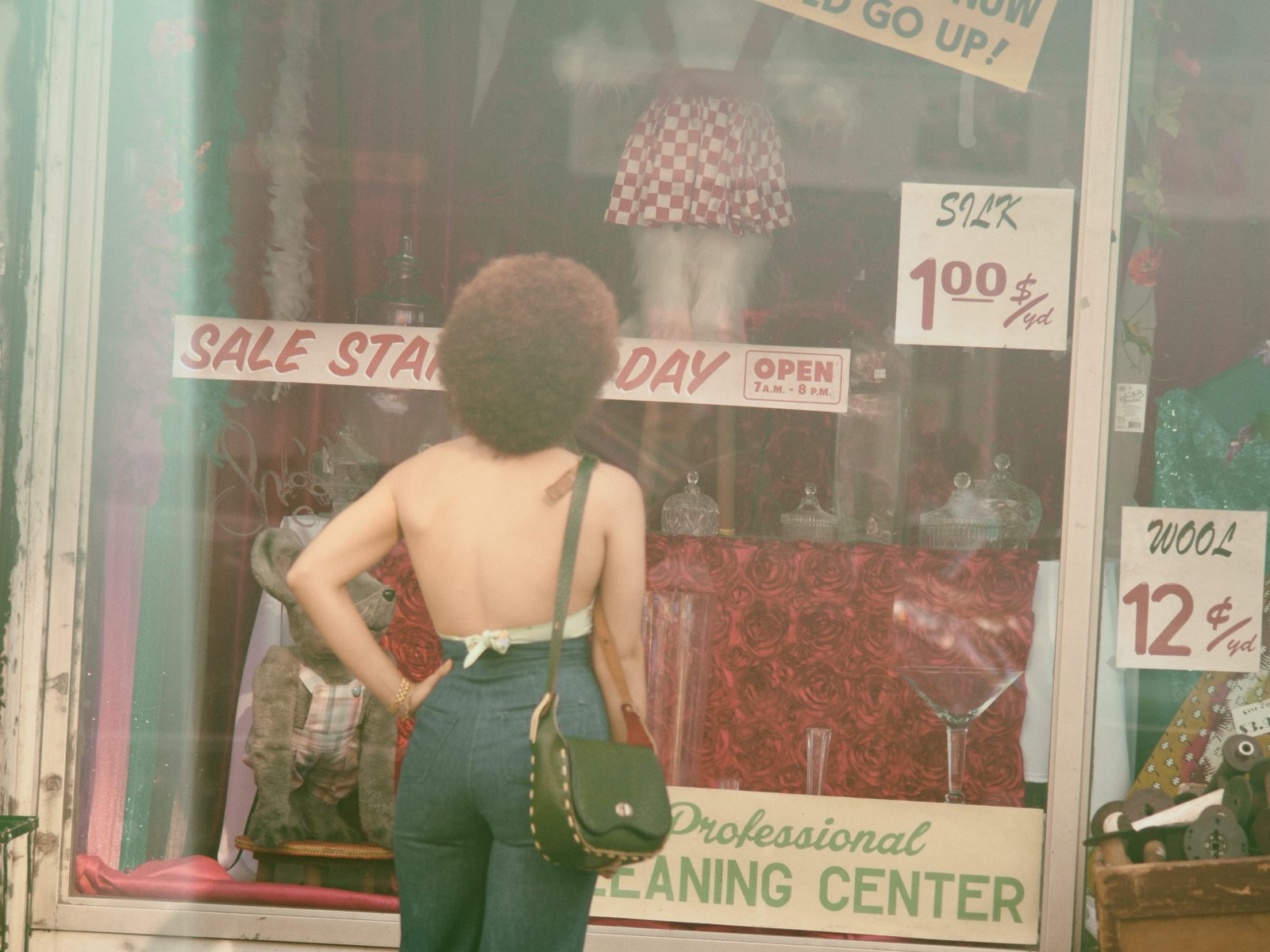 an-african-american-women-standing-in-front-of-a-store-window