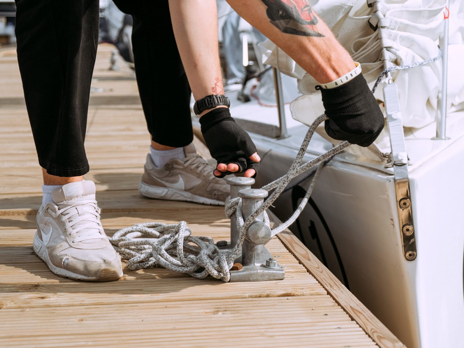 a-man-rigging-boat-to-the-dock