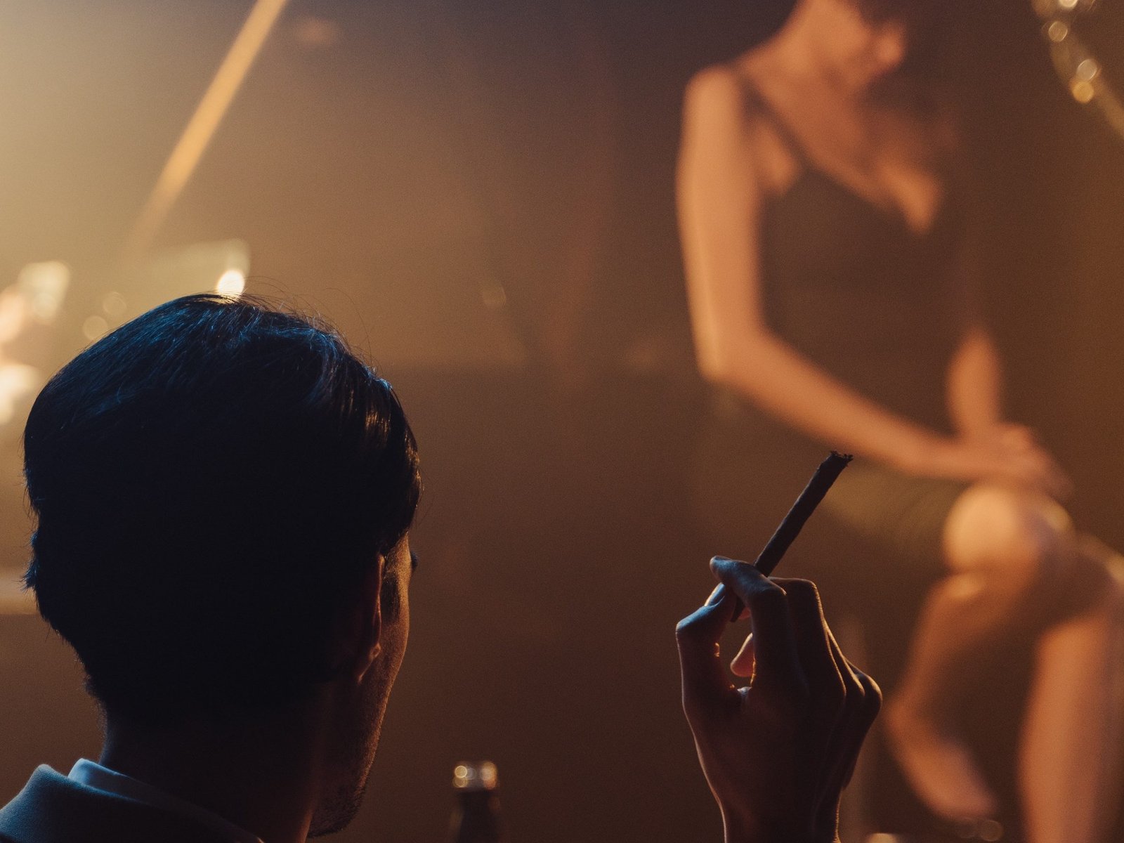 a-lady-singer-on-stage-a-gentleman-with-cigar-watching