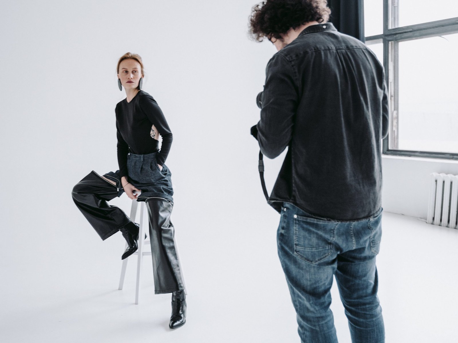 model-posing-in-front-of-photographer-in-studio