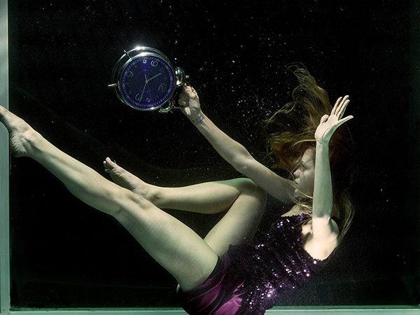 girl in water with clock